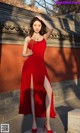 A woman in a red dress posing for a picture.