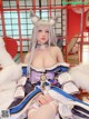 A woman in a cat costume sitting on a bed.
