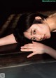 A woman laying on top of a wooden table.