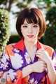 A woman in a kimono poses for a picture.