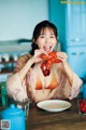 A woman sitting at a table eating a lobster.